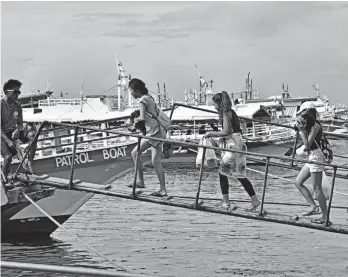  ?? MACKY LIM ?? SUMMER TRAVELS. Island hopping around the Island Garden City of Samal is a popular activity during the summer break, creating considerab­le foot traffic at the Sta. Ana Pier where the boats are docked.