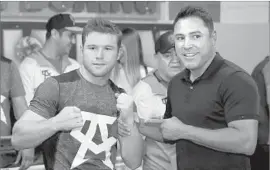  ?? Sean M. Haffey Getty Images ?? CANELO ALVAREZ, left, has “always had his career right on track,” says Oscar De La Hoya, who knows something about success in the boxing ring.