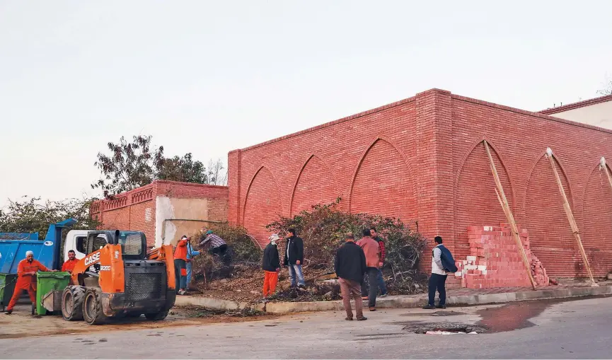  ??  ?? ↑
Municipal workers clear a small garden on the side of a cemetry where Hosni Mubarak is expected to be buried in Cairo’s eastern Nasr City district on Tuesday.
Agence France-presse