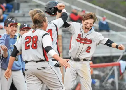  ?? SAM STEWART - DIGITAL FIRST MEDIA ?? Boyertown’s Mike Raineri (2) and Mitchell Peers (17) celebrate after Peers came home on an Anthony Rota double in the first inning.