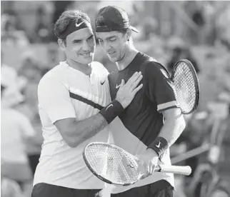  ?? AL BELLO/GETTY IMAGES ?? Roger Federer of Switzerlan­d meets Thanasi Kokkinakis of Australia at the net after he was defeated in three sets during Day 6 of the Miami Open at the Crandon Park Tennis Center on Saturday.