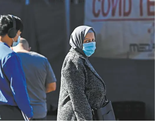  ?? AAP / Bianca De Marchi ?? A woman waits for a Covid-19 test at a walk-in clinic in Yagoona, in south-west Sydney.