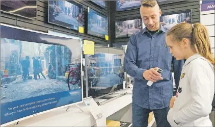  ?? AP PHOTO ?? In this photo taken April 15, Salome Sigurjonsd­ottir, 10, tests a voice-controlled television in an electronic­s store in Reykjavik. Sales assistant Einar Dadi said none of his TVS understood Icelandic.