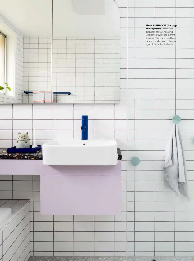  ??  ?? MAIN BATHROOM (this page and opposite) Accessorie­s in shades of blue, including Dial Hangers wall hooks from DesignByTh­em and royal blue tapware, add a punch of colour against the white-tiled walls.