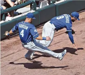  ?? Jonathan Daniel / Getty Images ?? The collision Sunday between left fielder Alex Gordon (4) and third baseman Mike Moustakas left Gordon with a broken wrist, Moustakas with a torn ACL and the Royals facing an uphill battle in a bid to defend their title.