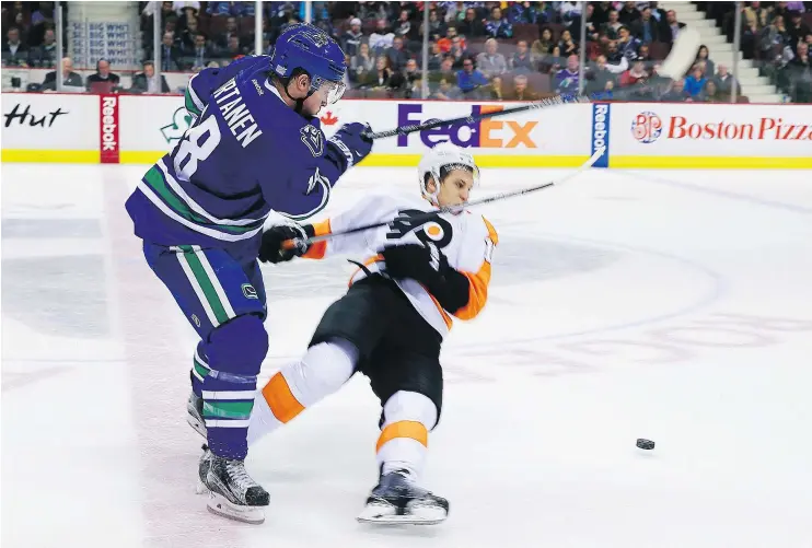  ?? — GETTY IMAGES FILES ?? Jake Virtanen knocks Philadelph­ia’s Brayden Schenn to the ice during Virtanen’s rookie profession­al season in 2015 at Rogers Arena.