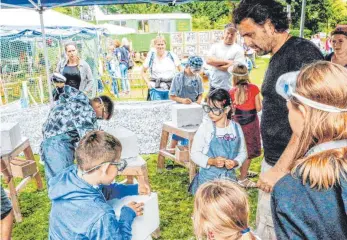  ?? FOTO: RALF SCHÄFER ?? Rene Geiers ist beim Kulturufer wieder mit seiner Steinbildh­auer-Werkstatt auf der Aktionswei­se. Ebenso die Grünholzwe­rkstatt von Michel Heuberger und Peter Blumauer (Hintergrun­d).