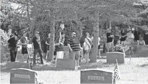  ?? ?? Residents gather for the ceremony at the Grove City Cemetery.