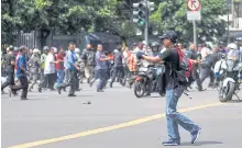  ?? XINHUA ?? A gunman points his weapon during the attacks. Police said the assault bore hallmarks of the Paris attacks.