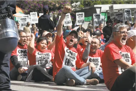  ?? Photos by Liz Hafalia / The Chronicle ?? Above: Hotel workers, union organizers and their supporters, including former city Supervisor John Avalos (far right), demonstrat­e in front of the St. Francis hotel in San Francisco. Below: A protester is led away by police, who arrested 75 people during the rally.