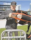  ?? KENNETH K. LAM/BALTIMORE SUN ?? Hitting coach Don Long unloads a bag of baseballs as the O’s get ready for batting practice before the 2019 season opener.
