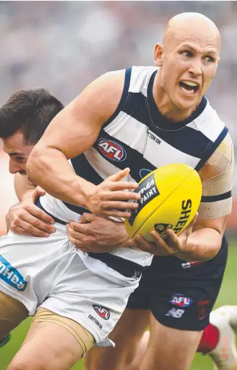  ?? Picture: GETTY ?? STILL GOT IT: Gary Ablett of the Cats handballs while being tackled yesterday.