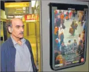  ?? AFP/FILE ?? Mehran Karimi Nasseri passes by the poster of the movie inspired by his life, at Paris airport on August 12, 2004.