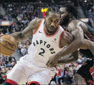  ?? —CP ?? The Raptors’ Kawhi Leonard (left) drives past the Heat’s Justise Winslow at Scotiabank Arena last night. Leonard finished the game with 29 points and 10 rebounds.