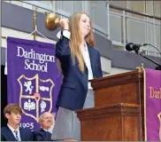  ?? John Popham ?? Kasey Barnett, Darlington student body president, rings in the new school year Thursday with a hand bell which was used to signal class changes at Darlington School in the early 1900s. The bell has been rung in the Darlington Opening Convocatio­n since 2005.