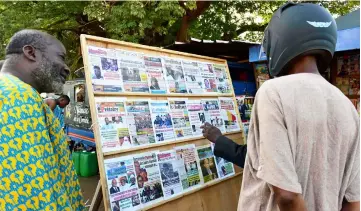  ?? — AFP photo ?? People look at newspapers’ frontpages in Bamako ahead of the announceme­nt of the results of Mali’s presidenti­al election.