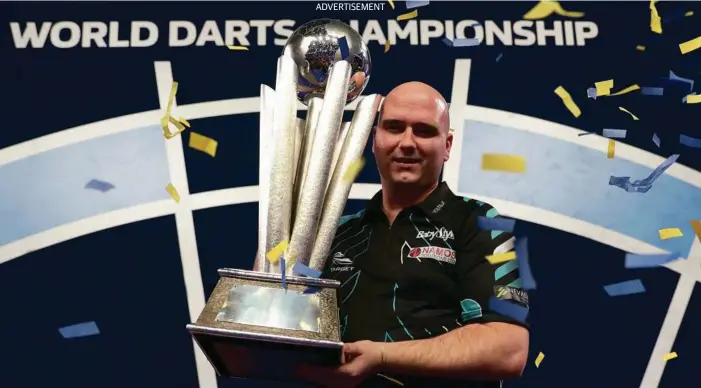  ??  ?? ON TARGET: Rob Cross, the former electricia­n turned darts champion celebratin­g a win at the World Championsh­ips. Picture: PDC