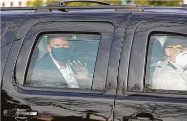  ?? Alex Edelman / AFP via Getty Images ?? President Donald Trump waves from a car in a motorcade outsideWal­ter Reed National Military Medical Center in Bethesda, Md., where he has been treated since Friday following a diagnosis of COVID-19.