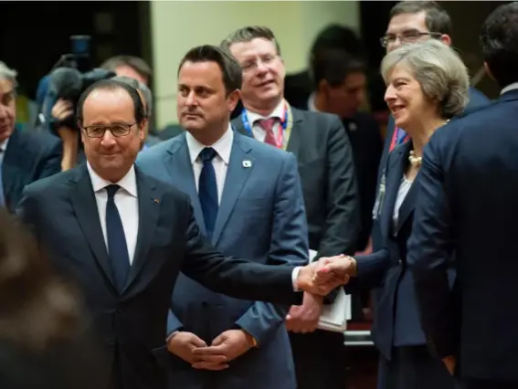  ??  ?? François Hollande and Theresa May shake hands in Brussels yesterday (AFP/Getty)