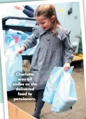  ??  ?? Charlotte was all smiles as she delivered food to pensioners.