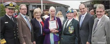  ??  ?? Judy Kearney with Minister Paul, Chief of Staff Vice Admiral Mark Mellett DSM, and other guests at the ceremony and (inset) Judy with the plaque she received during the citation.