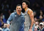  ?? Jeff Dean/Assocaited Press ?? Xavier coach Sean Miller speaks with Desmond Claude during a December game. The New Haven native is averaging 16 points, 4.8 rebounds and 4 assists per game for the Musketeers.