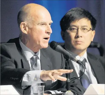  ?? John G Mabanglo European Pressphoto Agency ?? GOV. JERRY BROWN, left, and Treasurer John Chiang figure that the one-time payment will save the state and its localities $11 billion during the next 30 years via reduced CalPERS contributi­ons.