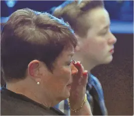  ?? STAFF PHOTOS BY CHRISTOPHE­R EVANS ?? A HERO: Clockwise from above, Denise Morency Gannon wipes away tears; Yarmouth police Chief Frank Fredericks­on speaks; Rylee, 12, stands with Patrick Gannon yesterday at a ceremony posthumous­ly naming fallen Sgt. Sean Gannon ‘Big of the Year.’