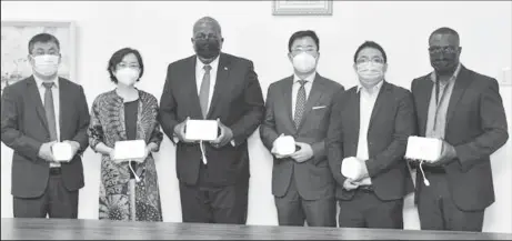  ?? ?? Prime Minister Mark Phillips (third from left) with one of the boxes. China’s Ambassador Guo Haiyan is second from left