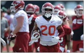  ?? (NWA Democrat-Gazette/Andy Shupe) ?? Sophomore Dominique Johnson was the recipient of some good-natured humor by Arkansas Coach Sam Pittman on Wednesday night. Johnson was moved from running back to tight end earlier in camp before returning to the backfield. “He was like twice as good,” Pittman said. “But really, he got a lot better. I don’t know why, but he did. He started running the ball better.”