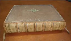  ?? HANNAH CRUMME, THE ASSOCIATED PRESS ?? A 1599 Geneva Bible printed in London by a printer for Queen Elizabeth, sat forgotten in the basement of Lewis &amp; Clark College’s Aubrey R. Watzek Library in Portland, Oregon.