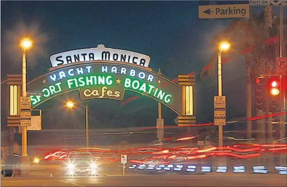  ?? Luis Sinco Los Angeles Times ?? WITH A BEACH and pier that were made for picture postcards, Santa Monica plays host to millions of visitors each year.