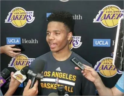  ?? GREG BEACHAM — THE ASSOCIATED PRESS ?? Markelle Fultz, center, speaks with reporters after his private workout with the Los Angeles Lakers at the team’s training facility in El Segundo, Calif. Thursday. Two nights later, he was in Camden, shaking hands and shooting with a somewhat unsteady...