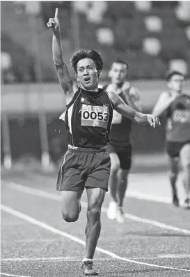  ?? CONTRIBUTE­D PHOTO ?? FIRST. Palawan-Philippine­s’s Jhon Lloyd Cabalo flashes the No. 1 sign as he reaches the finish line first to annex the men’s 400-meter gold medal Friday evening in the first day of BIMPNT-Eaga Friendship Games 2018 athletics competitio­n at the Hassanal Bolkiah National Sports Complex in Bandar Seri Begawan, Brunei.