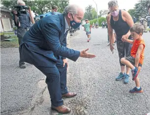  ?? RYAN REMIORZ THE CANADIAN PRESS ?? Conservati­ve Leader Erin O’Toole greets a child in Ottawa on Aug. 19. According to an analysis, a Tory child-care tax credit would result in less savings for most families that pay for child care.