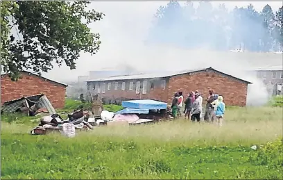  ?? PHOTO: JEFF HASSAN ?? ON FIRE: Buildings at the hostel in Mooi River burn after the township residents ’ attack which was sparked by the killing of a 22-year-old man, allegedly by a hostel dweller