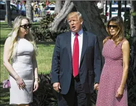  ?? BRUCE R. BENNETT / PALM BEACH POST ?? President Donald Trump speaks to reporters as he, daughter Tiffany Trump (left) and first lady Melania Trump arrive at the Episcopal Church of Bethesda-by-the-Sea in Palm Beach, Fla., for Easter Sunday services.