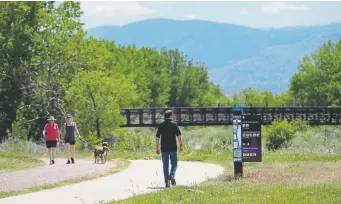  ?? Kathryn Scott, Denver Post file ?? Hikers use a section of the Mary Carter Greenway Trail in Littleton, where new signs were installed in 2017.