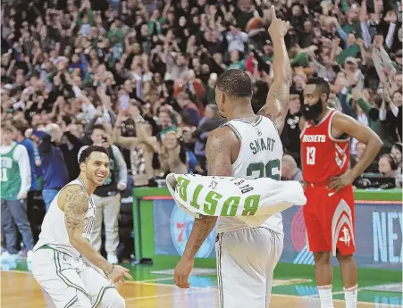  ?? STAFF PHOTO BY MATT STONE ?? YES! Shane Larkin and Marcus Smart celebrate after the Celtics rallied from a 26-point deficit to beat the Rockets last night at the Garden.