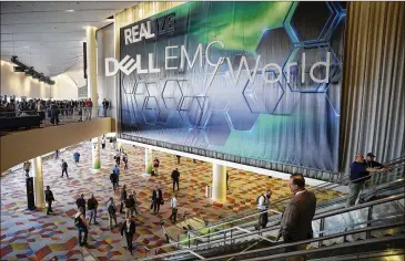 ?? PHOTOS BY JOHN LOCHER / ASSOCIATED PRESS ?? People attend the Dell EMC World conference in Las Vegas on Monday. To make it easier for more people to attend, Dell moved the conference out of Austin after buying EMC Corp. last year.