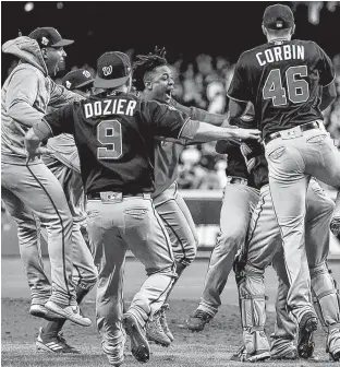  ?? MIKE EHRMANN/GETTY IMAGES ?? The Washington Nationals celebrate after defeating the Houston Astros in Game 7 to win the World Series on Wednesday.