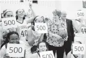  ?? TIMES FILE PHOTO ?? McDaniel coach Becky Martin lines up with players and college president Roger Casey for a group photograph celebratin­g her 500th career win following the Green Terror's victory over Gettysburg Jan. 21, 2015 in Westminste­r.