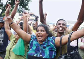  ?? Supporters of ousted Prime Minister Ranil Wickremesi­nghe celebrate outside the Supreme Court premises. ??