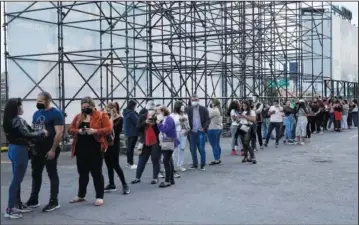  ?? (File Photo/AP/Ariana Cubillos) ?? People line up March 3 to get into the concert of Fernandez and Colombian singer Jessi Uribe in Caracas.