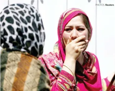  ?? PHOTOS: Reuters ?? Women mourn outside a Kabul hospital after a truck-bomb attack