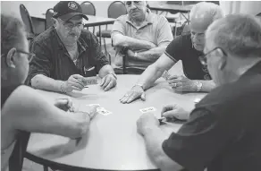  ??  ?? Members of the Dante Club play Scopa, a traditiona­l Italian card game. The club has been a bulwark against a sometimes hostile English-Canadian mainstream culture.