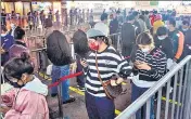  ?? ?? Passengers queue to undergo nucleic acid tests for Covid-19 in Hangzhou in China’s Zhejiang province on Monday.