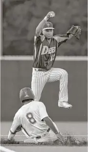  ?? Jerry Baker ?? Deer Park shortstop Josiah Ortiz jumps to avoid the slide of Travis’ Dominic Cox in the third inning of the Region III-6A series opener Thursday night.