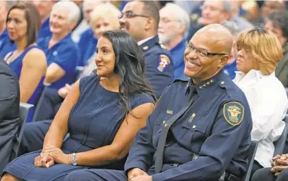  ?? PAUL MOSELEY/FORT WORTH STAR-TELEGRAM ?? Joel Fitzgerald, laughing with his wife, Pauline, left, was sworn in as the chief of the Fort Worth Police Department on Oct. 20, 2015. Mayor Catherine Pugh confirmed Friday that he is her choice to be the next Baltimore police commission­er.