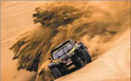  ?? PHOTOS BY JIANG WENYAO /XINHUA ?? Swiss driver Remy Vauthier scrambles through the desert during the Taklimakan Rally in Xinjiang.